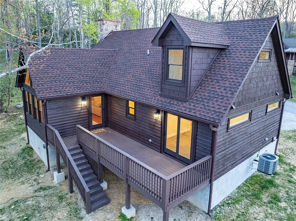 Timber cabin with a wraparound deck and exterior stairs
